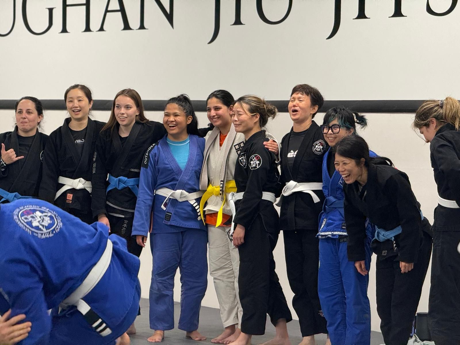 Women and kids lined up and laughing at the summer grading