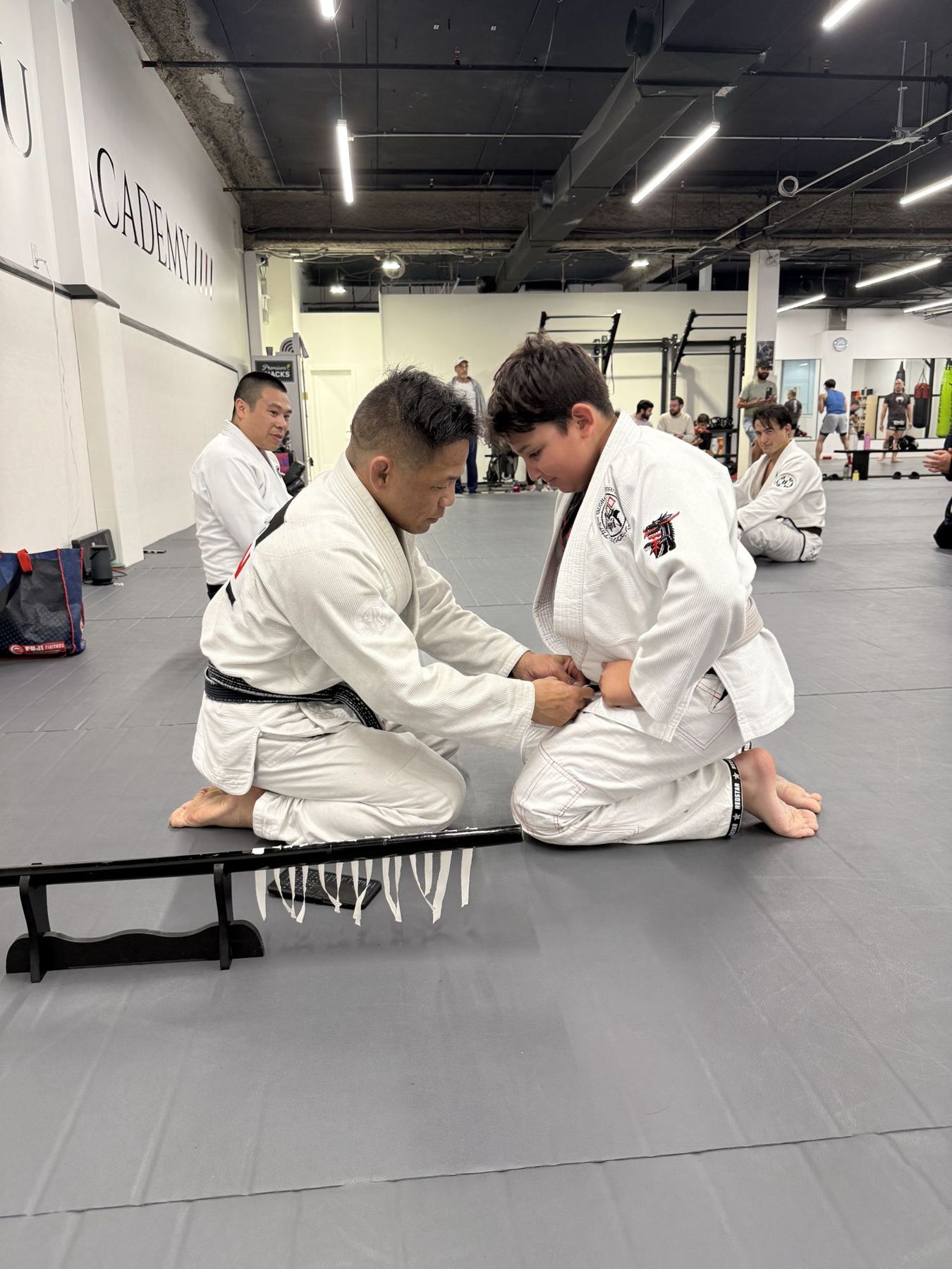Black belt instructor presenting a new belt