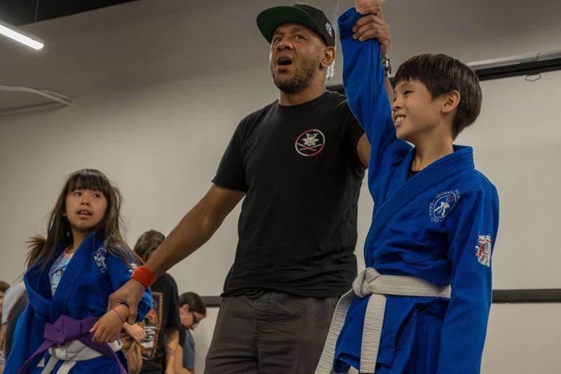 Coach celebrating with a young winner
