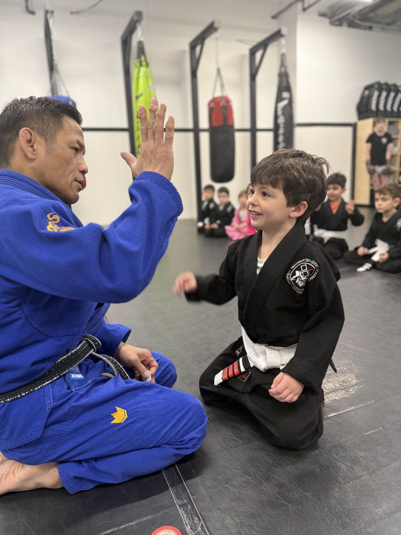 Coach high-fiving a kid after his new stripe